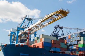 Container ship in port at container terminal close-up. Ships of container ships stand in terminal...