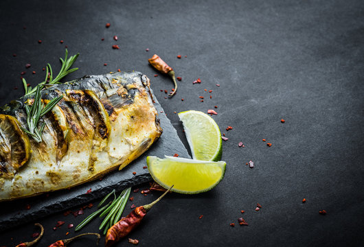 Fried fish scomber fillets with lime and herbs