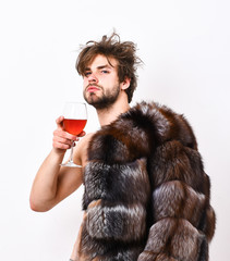 Guy attractive posing fur coat on naked body. Luxury status symbol. Sexy sleepy macho tousled hair...