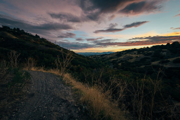 Fototapeta na wymiar Deep colorful sunset over the hills