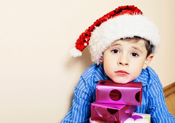 little cute boy with Christmas gifts at home. close up emotional