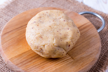 Raw wheat dough on cutting board