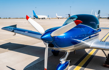 Shiny blue sport plane at the airport sunshine runway