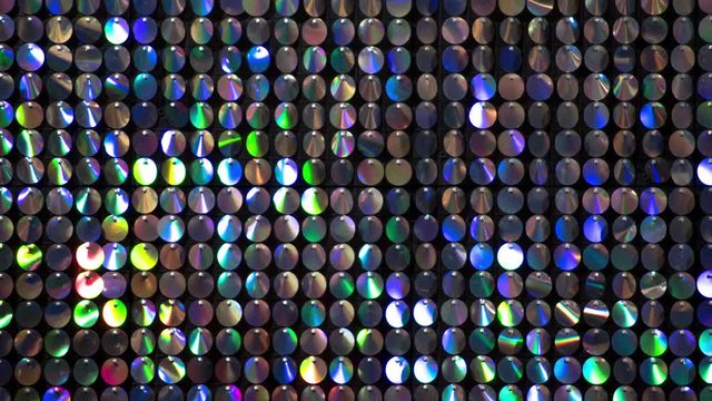 Shiny Reflective Metallic Disc Background Glittering With Colors - Looping Time Lapse