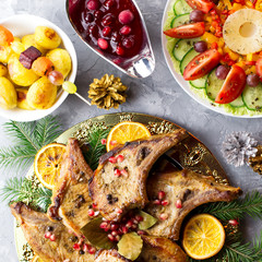 Christmas dinner with roasted meat steak, Christmas Wreath salad, baked potato, grilled vegetables, cranberry sauce.