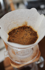 Coffee blooming in paper filter close up