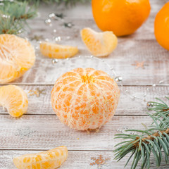 Peeled tangerines on wooden background