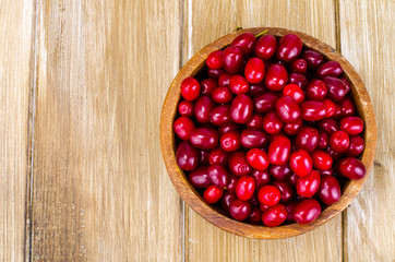 Autumn ripe cornel berries on wooden table