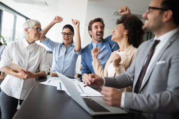 Business team celebrating a good job in the office