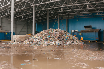 A pile of garbage in a waste storage area at a waste sorting plant. Technological process. Business for sorting and recycling.