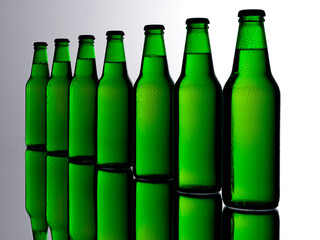 SEVEN GREEN BEER BOTTLES
