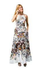 Blonde young girl in a summer dress keeping a conversation with the mobile phone with someone on isolated white backgroun