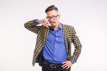 Handsome man in jacket with beard and mustache in glasses having fun over white background