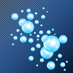 Realistic soap bubbles with rainbow reflection set isolated on the blue transparent background.