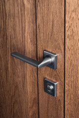 Obraz premium Close - up of modern steel door handle and bathroom lock