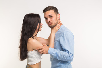 Relationship problems, conflict and domestic abuse - Angry wife try to strangle unfaithful husband on white background