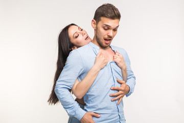 Relationship and love concept - Portrait of funny couple on white background