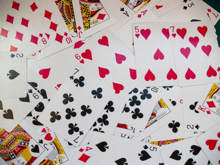 A deck of poker cards on a green rug