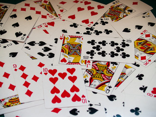 A deck of poker cards on a green rug