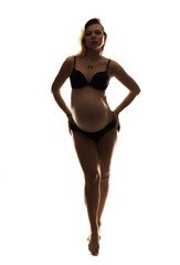 Artistic silhouette of blonde pregnant woman on isolated background