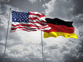 United States of America, USA & Germany Flags are waving in the sky with dark clouds