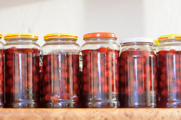 Homemade cherry juice. Cherries in jars freshly after breaking the tree. Stocks for the winter