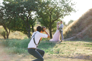 wedding photographer takes pictures of bride and groom