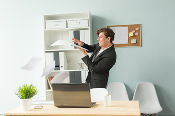 Naklejka premium Business, joke, people concept - handsome young man in suit having fun in the office