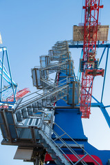 Cranes of container terminal cose up in industrial sea port. industrial port with containers