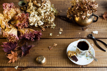 Autumn still life with dried leaves end flowers.