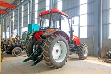 Poster large tractor in storage workshop © YuanGeng