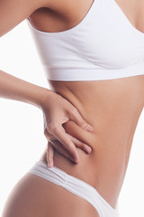 Woman shows percentage of fat. Isolated on white