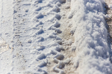 Traces of cars in the snow as a background