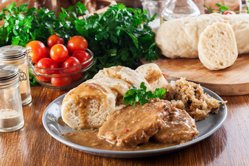 Pork loin in gravy with bread dumplings and sauerkraut