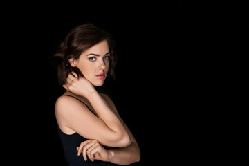 Naklejka premium Portrait of beautiful young woman on dark background