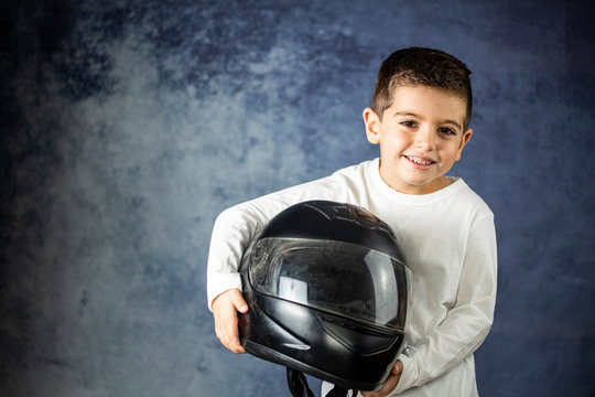 Little Kid Playing With A Motorcycle Helmet