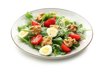 Delicious fresh salad with walnuts on plate, isolated on white