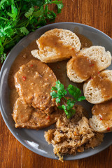 Pork loin in gravy with bread dumplings and sauerkraut