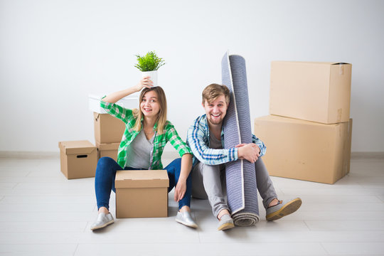 Relocation, real estate and moving concept - young couple people moved to a new apartment