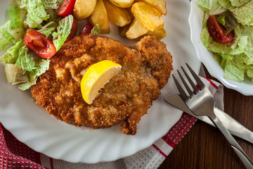 Breaded viennese schnitzel with baked potatoes