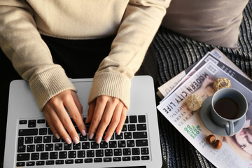 Obraz na płótnie Canvas Woman using laptop at home, closeup