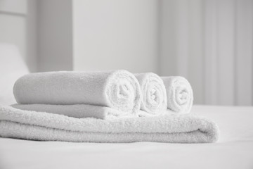 White soft towels on bed indoors