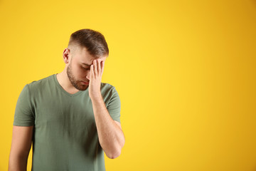 Emotional young man after making mistake on color background