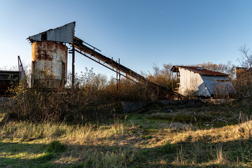 Fototapeta na wymiar Abandoned lime quarry, buildings and machinery in Bridgend, South Wales, Uk