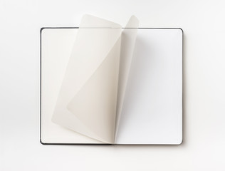 Top view of black notebook with curl rolled page
