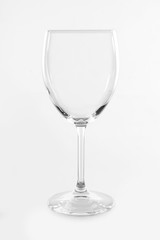 Empty wineglass on light background