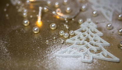 Background for winter celebrations with Christmas tree ornaments, pearls and snow.