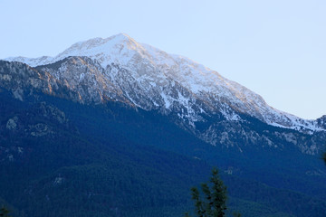 Mountains in winter. Show on mountain peak. Everest style rock climbing. Goal achieving. Inspirational training background.