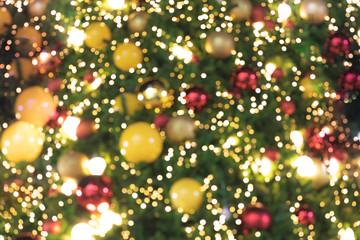 Obraz na płótnie Canvas de focused glittering lights of Christmas Tree Bokeh background