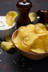 Crispy fried potato chips with salt and cream dip